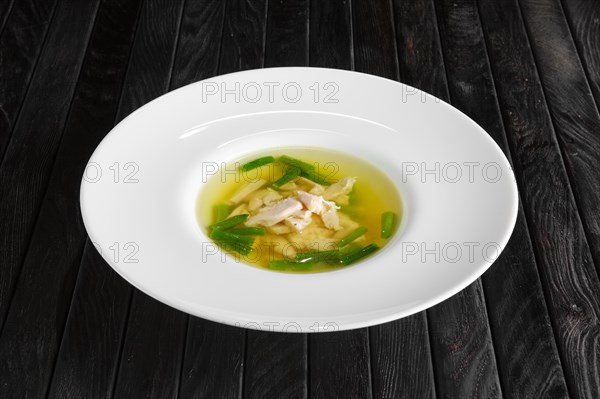 Clear broth with chicken and green beans