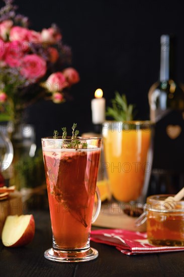 Composition with herbal and fruit hot alcohol drinks with ingredients on the table