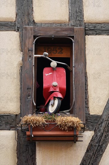 Decorated window on a half-timbered house in the historic old town of Riquewihr