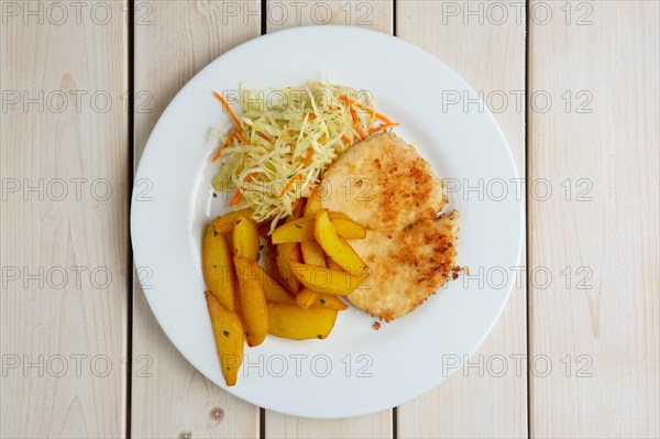 Chop cutlet with fried potato and fresh cabbage and carrot