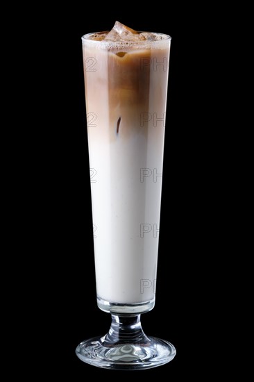 Tall narrow glass with iced coffee isolated on black background