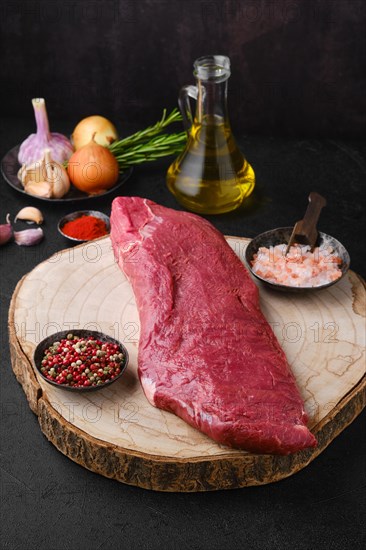 Overhead view of raw beef tri-tip roast with spice and seasoning ready for cooking