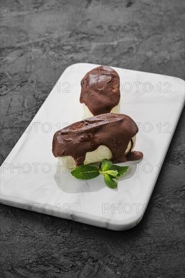 Glazed curd with chocolate on marble plate