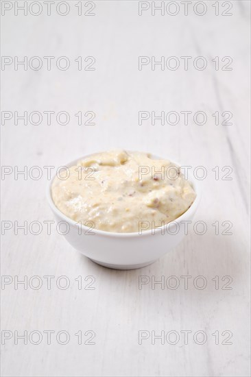 Small bowl with caesar sauce for salad