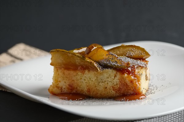 Piece of pear pie with poppy and sauce