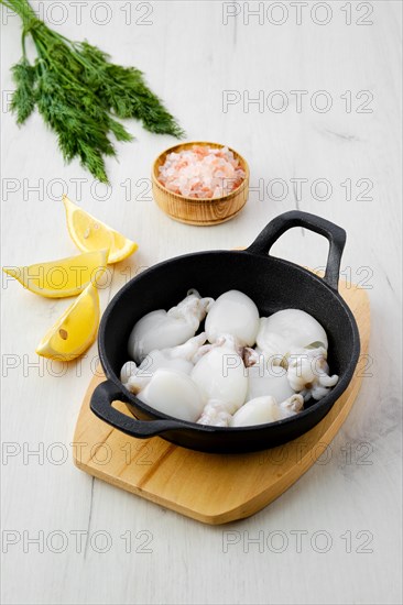 Baby cuttlefish in cast iron skillet with dill