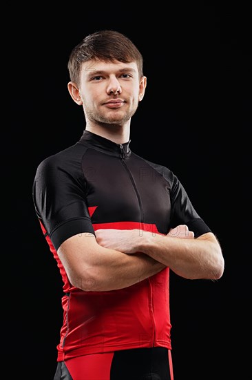 Sport. Cyclist in training clothes on black background