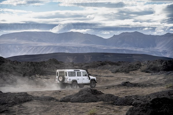 White Land Rover on a dirt road