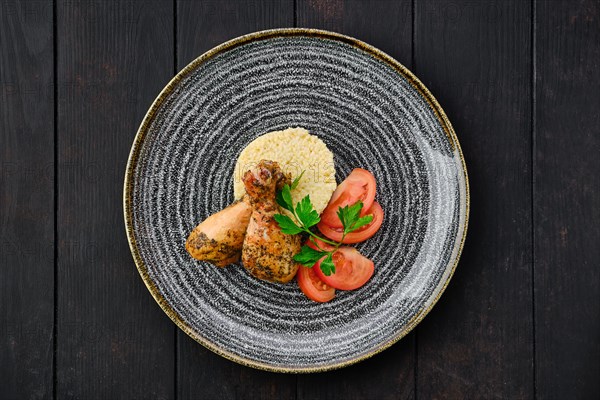 Top view of fried chicken leg with millet porridge