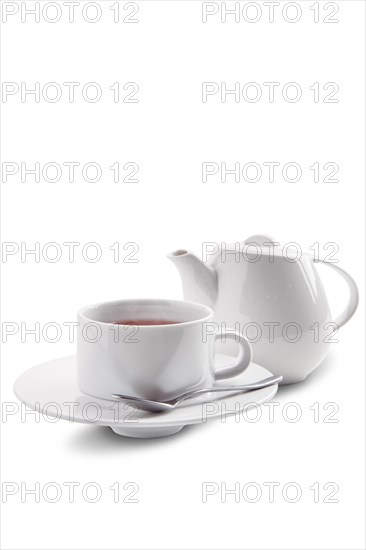 Ceramic tea cup and pot with Dilmah tea isolated on white