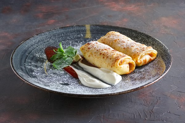 Thin pancakes with curd and sour cream