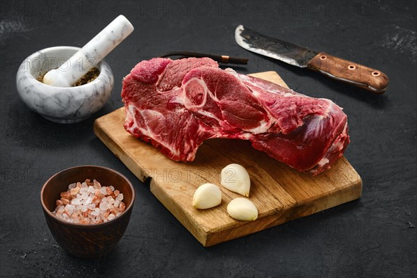 Raw lamb rump on wooden cutting board