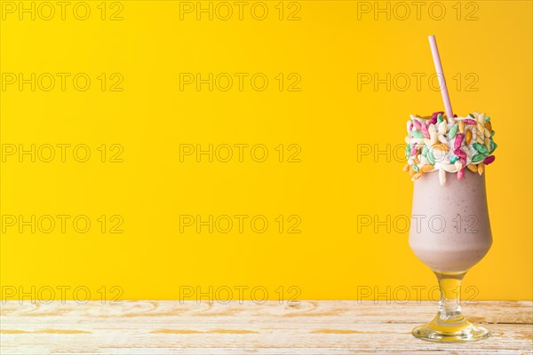 Front view delicious milkshake yellow background