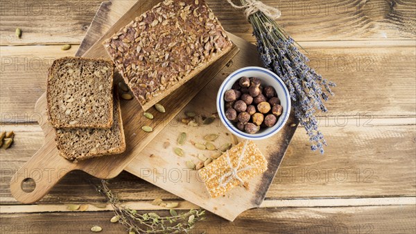 Top view whole grain bread hazelnut bowl with protein bar chopping board. Resolution and high quality beautiful photo