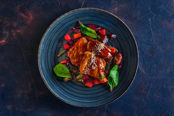 Top view of roasted pike served with beetroot