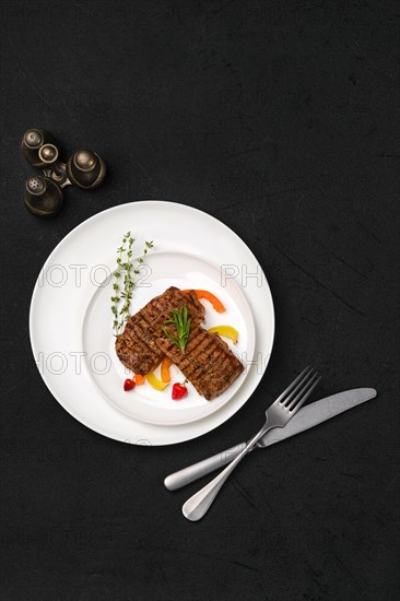 Top view of two grilled steaks on a plate