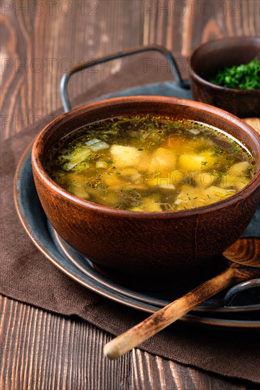 Rustic lunch with champignon soup on wooden table