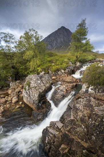 Waterfalls in front of mountain range Buachaille Etive Mor