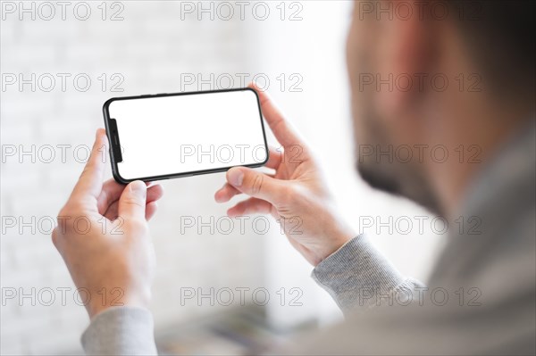 Close up man holding smartphone