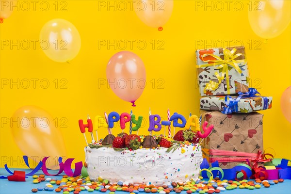 Front view birthday cake with presents