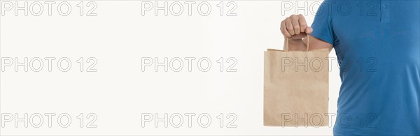 Man holding paper bag with copy space. Resolution and high quality beautiful photo