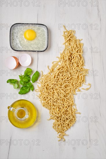 Top view of composition with homemade noodles on kitchen table