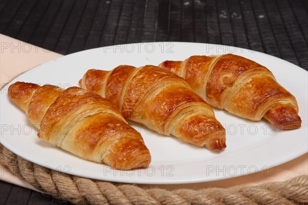 Fresh baked croissants on plate