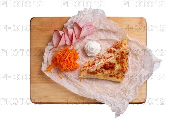 Thin pancakes stuffed with ham and spicy carrot isolated on white