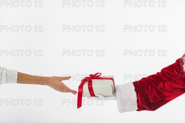Young woman taking small gift box santa claus. Resolution and high quality beautiful photo