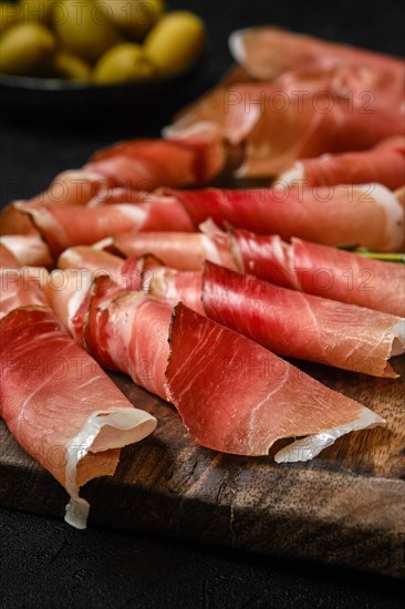 Closeup view of rolled slices of prosciutto ham