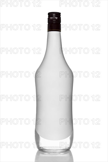 Bottle of alcohol beverage with coconut flavour with reflection on white background