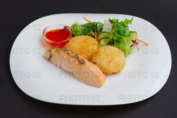 Fried salmon with rice cutlet and spicy sauce