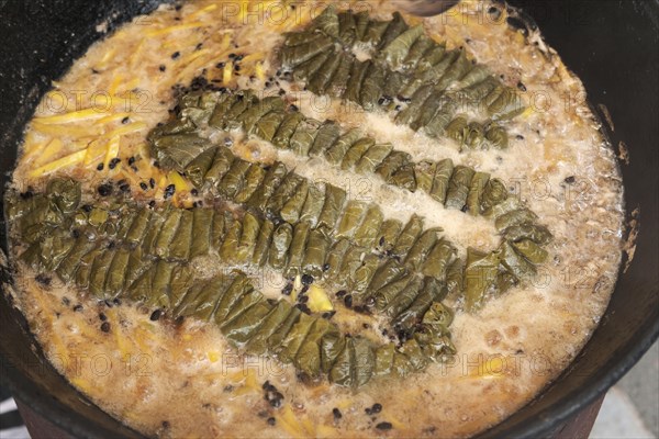 Meat and dolma in cauldron. The making of pilaf