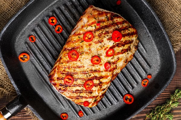 Close up view of grilled meat on cast-iron pan