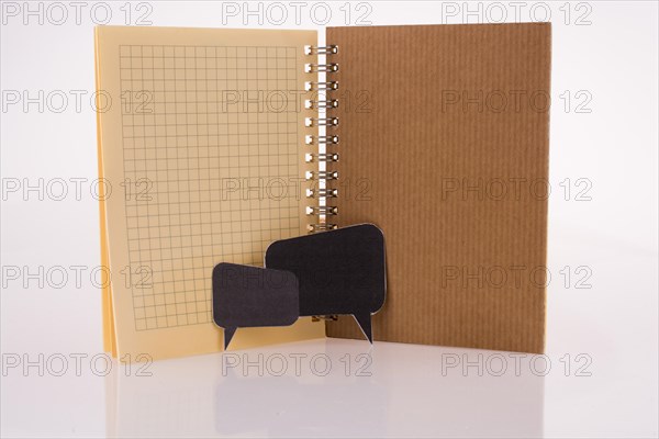 Dialogue boxes near a notebook on a white background