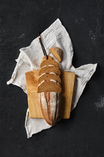 Overhead view of rue bread on dark background