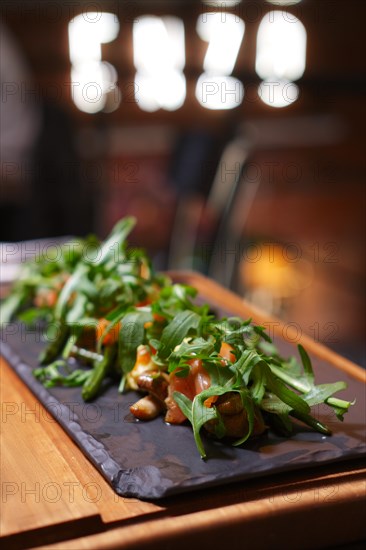 Smoked salmon with mushroom and bean decorated with ruccola. Photo taken with shallow depth of field