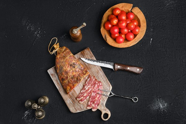 Homemade smoked pork sausage in organic casing on wooden cutting board