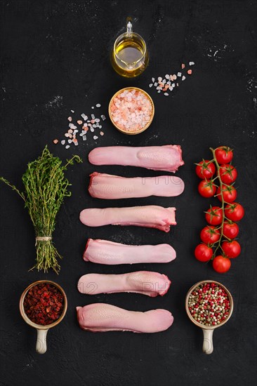 Composition with fresh raw lamb tongue with spice and herbs