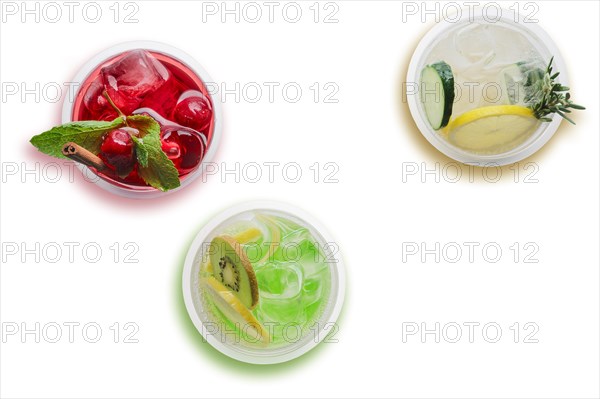 Top view of three glasses with cool lemonade isolated on white background