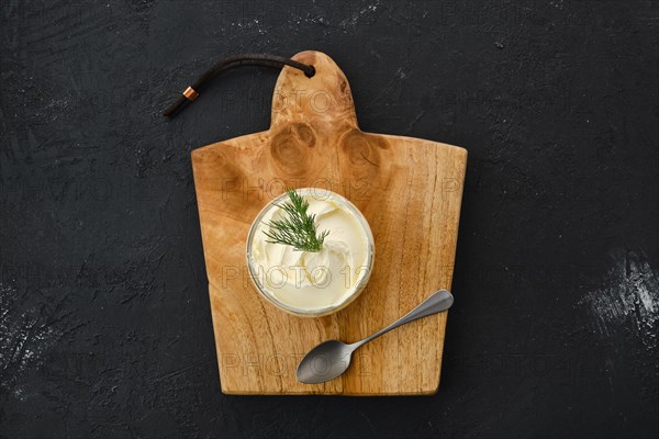 Top view of fat sour cream in a glass pot