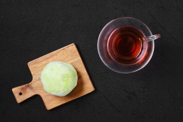 Top view of sweet dessert mochi with kiwi with fruit tea