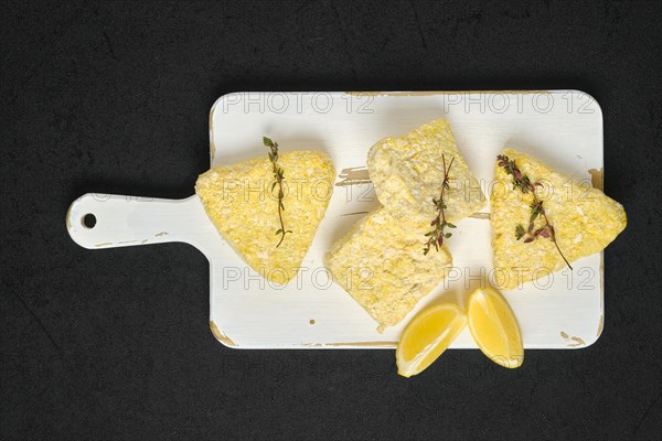 Top view of semifinished frozen fish patty in breading for quick cooking