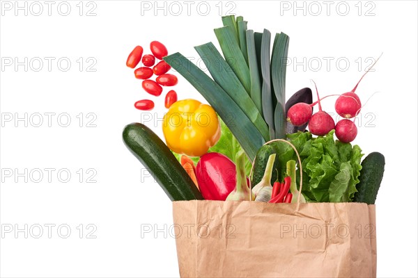 Paper bag with fresh vegetables isolated on white background