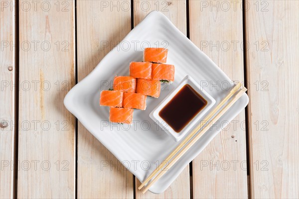 Top view of rolls with trout and chuka salad