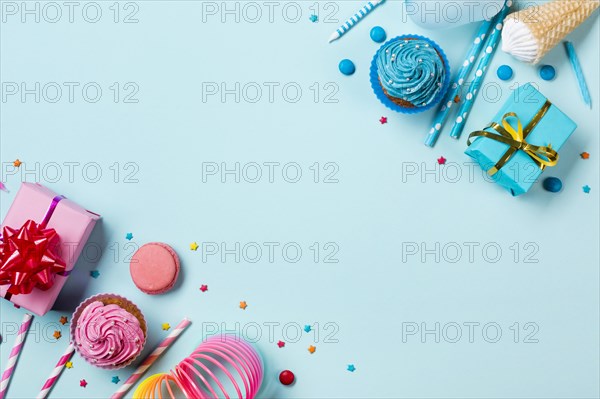 Pink blue colored party items with confectionery colored backdrop