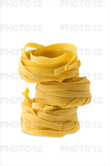 Nest noodles isolated on white background. Italian tagliatelle with egg