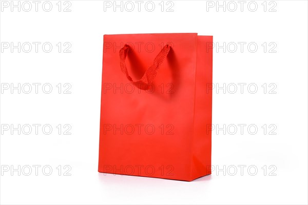 Red paper shopping gift bag on white background