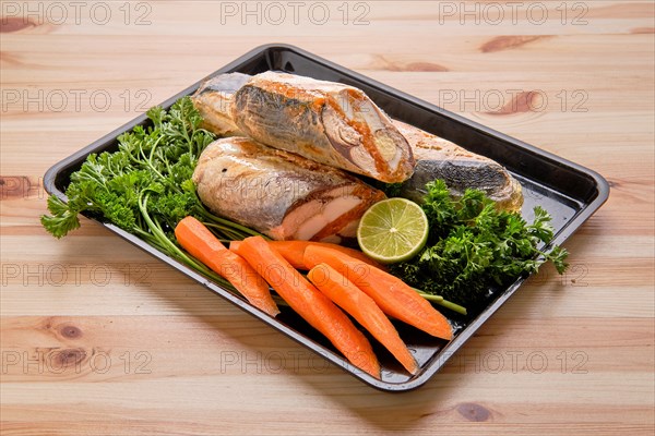 Rolled fish with egg and spices on tray