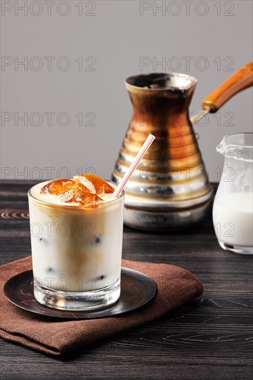 Iced latte with frozen coffee cubes and sweet cream